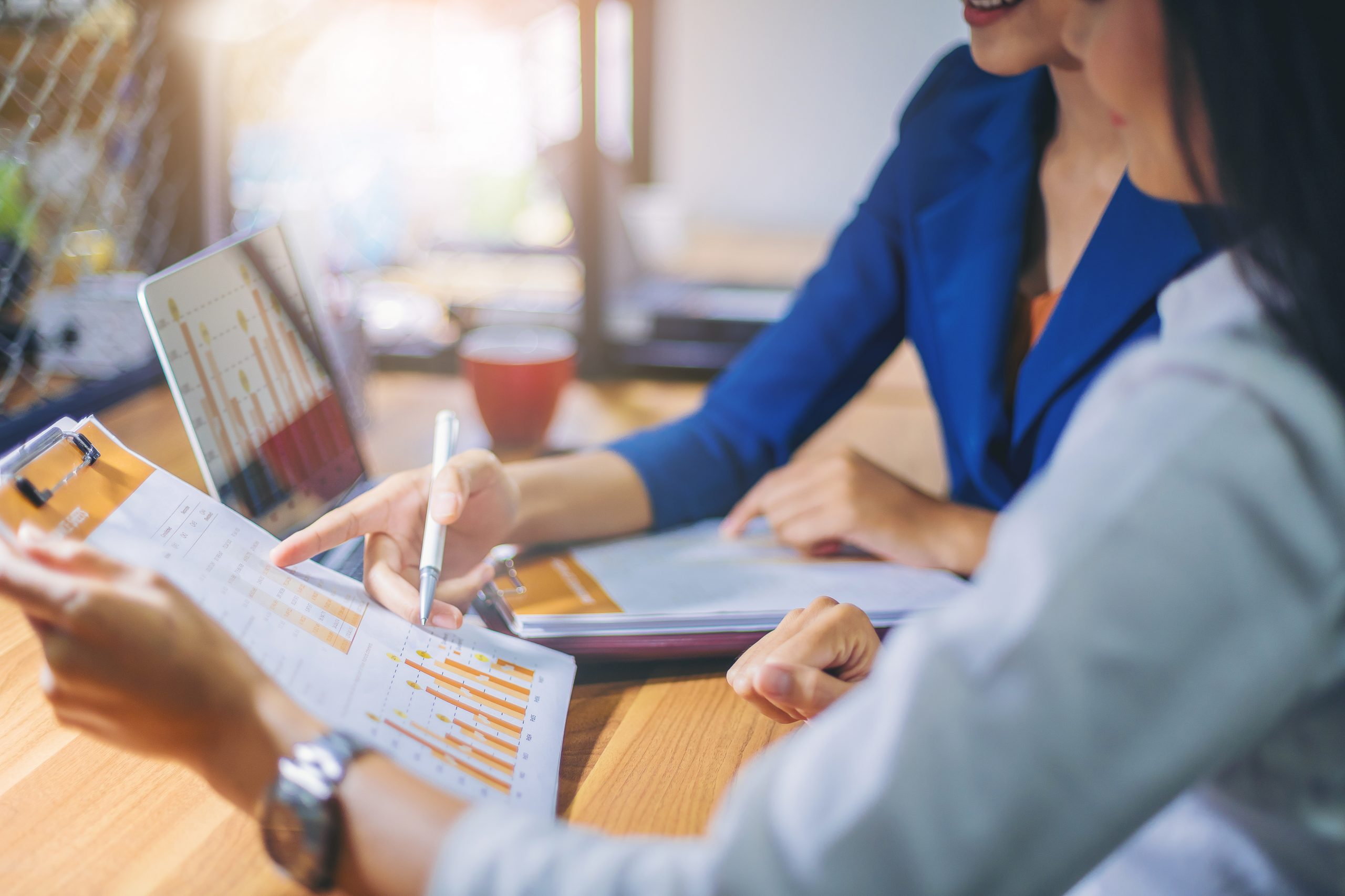 Businesswomen analyzing data togehter in teamwork for planning and startup new project.