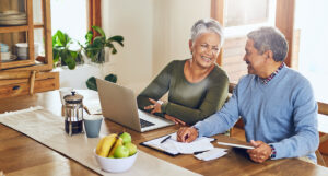 People reviewing financial plans and smiling