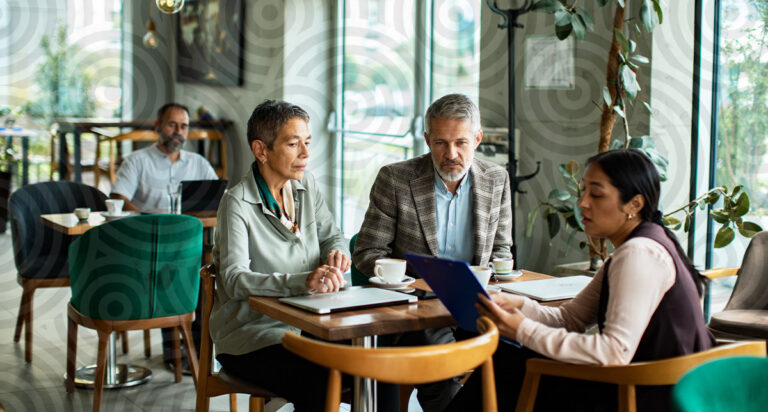 An advisor overviewing financial plan with clients in a public setting